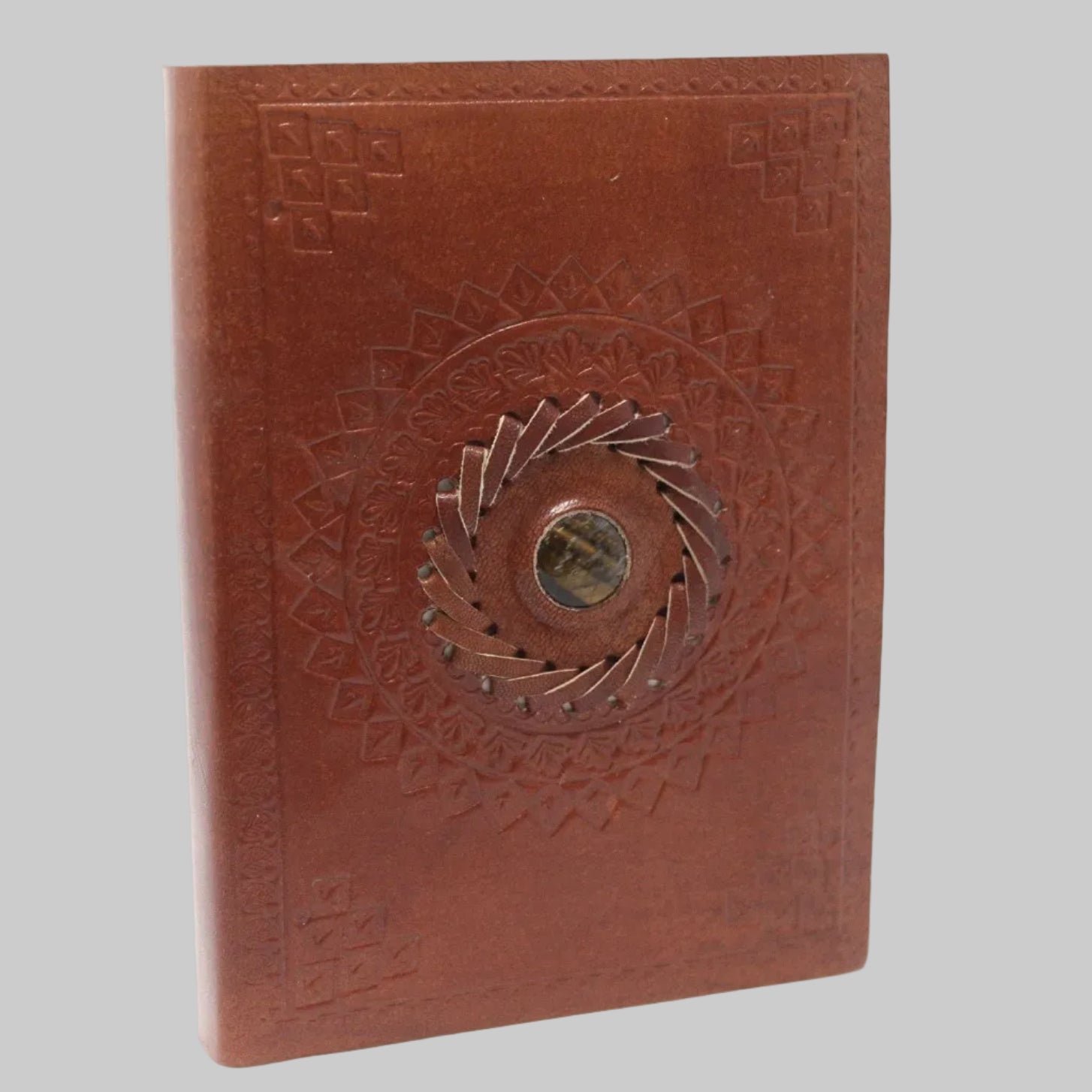 Brown leather notebook with embossed design on a white background