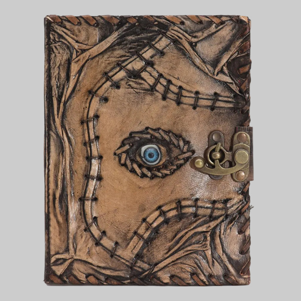 Leather-bound notebook with a face design and lock on a white background
