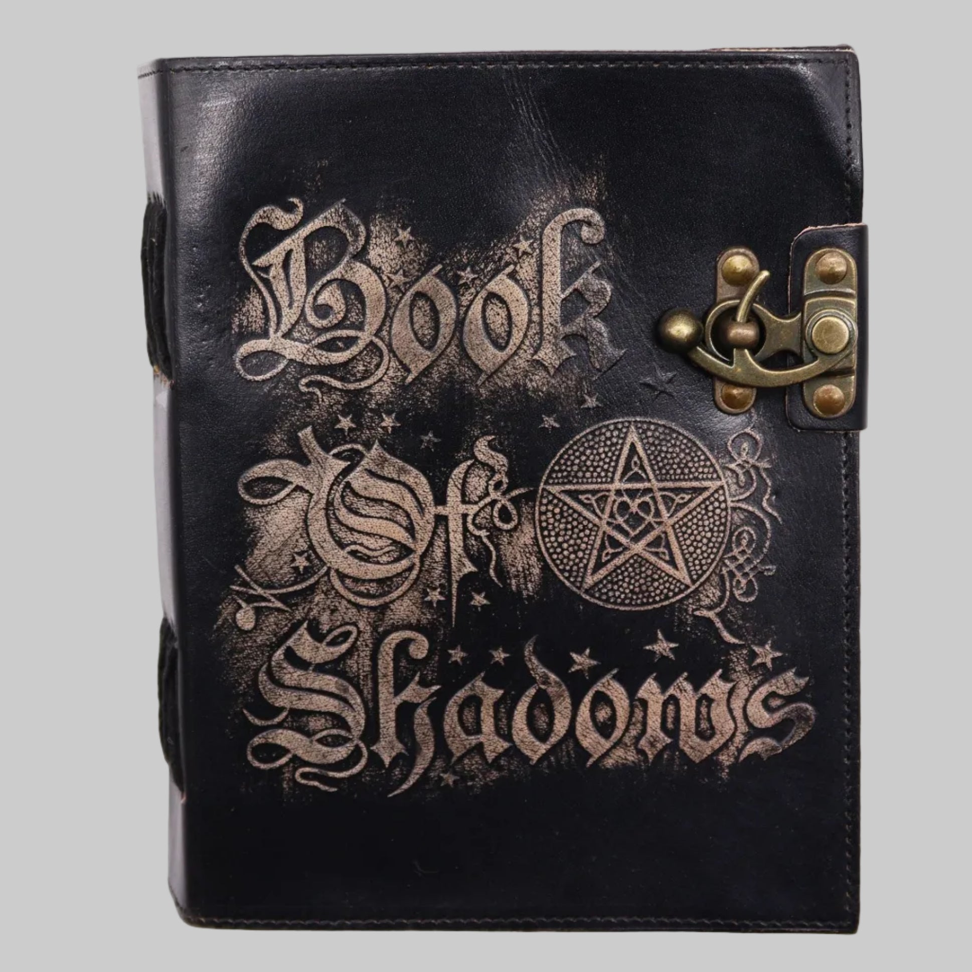 Black leather-bound book with 'Book of Shadows' text and pentacle symbol on a white background