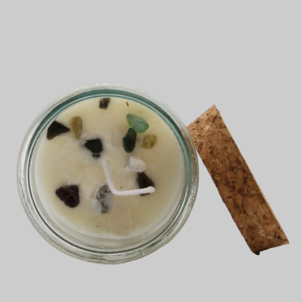 Candle in a glass jar with decorative elements on a white background