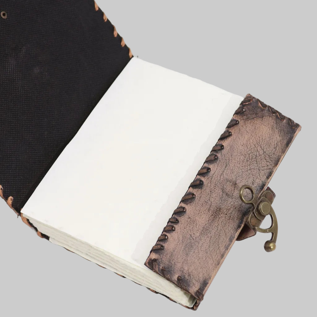 Handmade leather-bound notebook with a metal clasp on a white background
