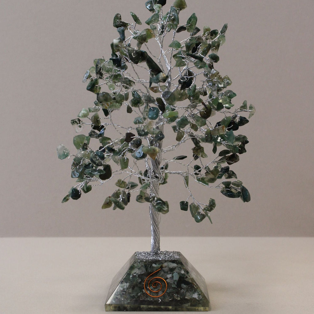 Decorative tree made of green stones on a gray background