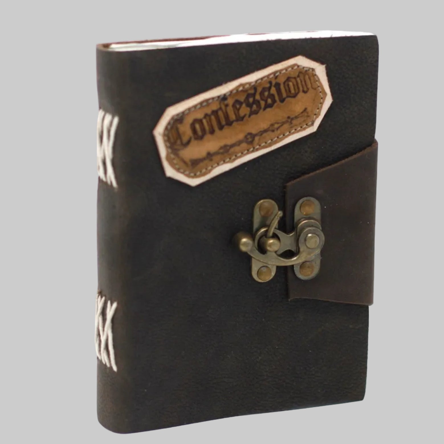 Black leather notebook with a gold lock and 'Confession' patch on a white background