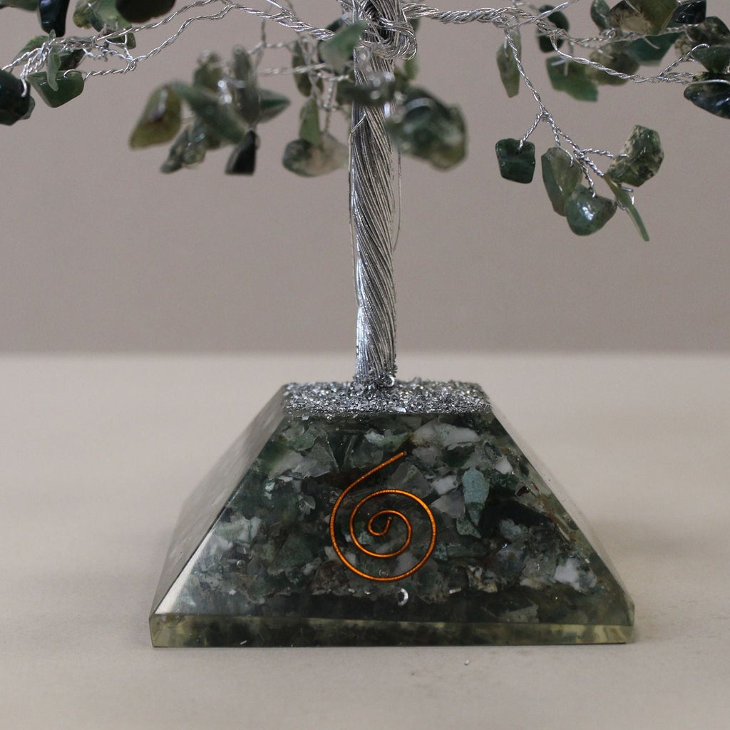 Decorative stone pyramid with a spiral design on a neutral background