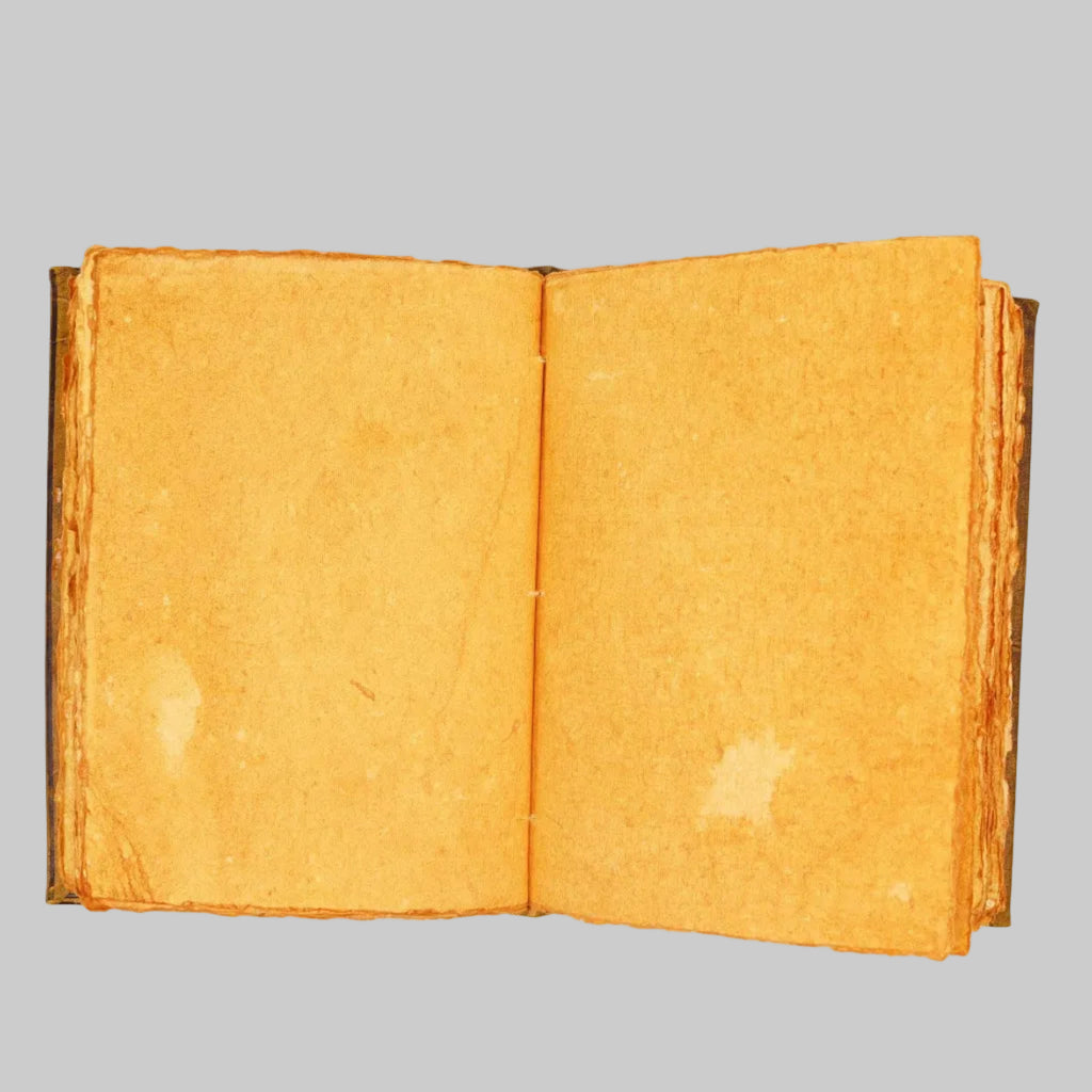 Open book with yellowed pages on a white background