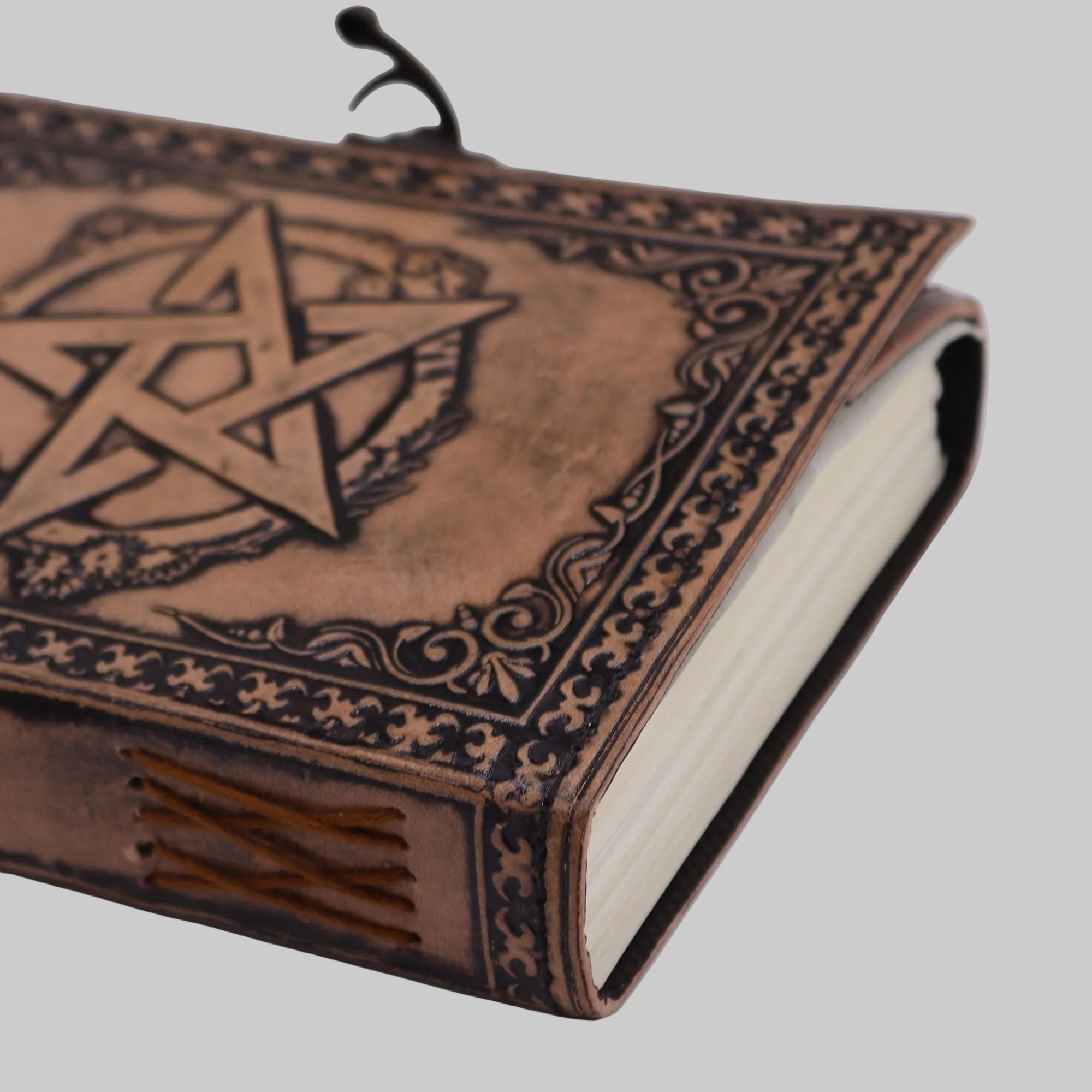 Decorative leather-bound book with star design on a white background