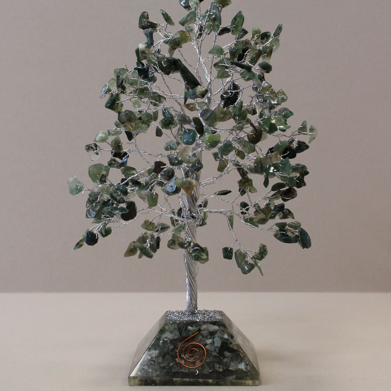 Crystal tree sculpture on a gray background