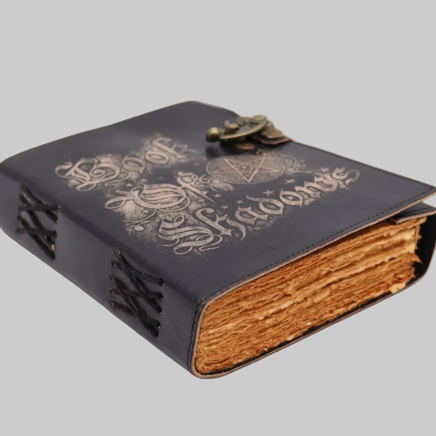 Black leather-bound book with gold embossed text on a white background