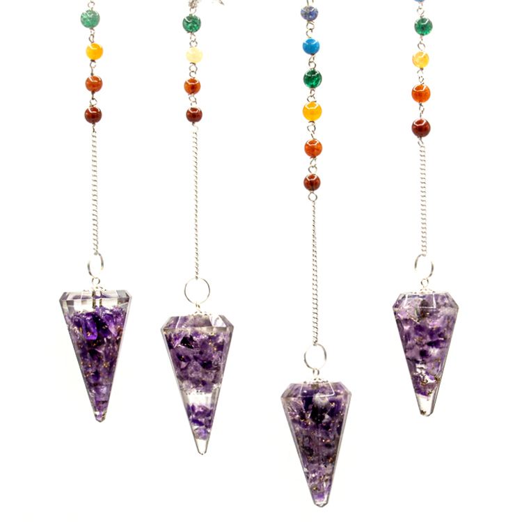Set of four purple crystal pendulums with colorful beads on white background