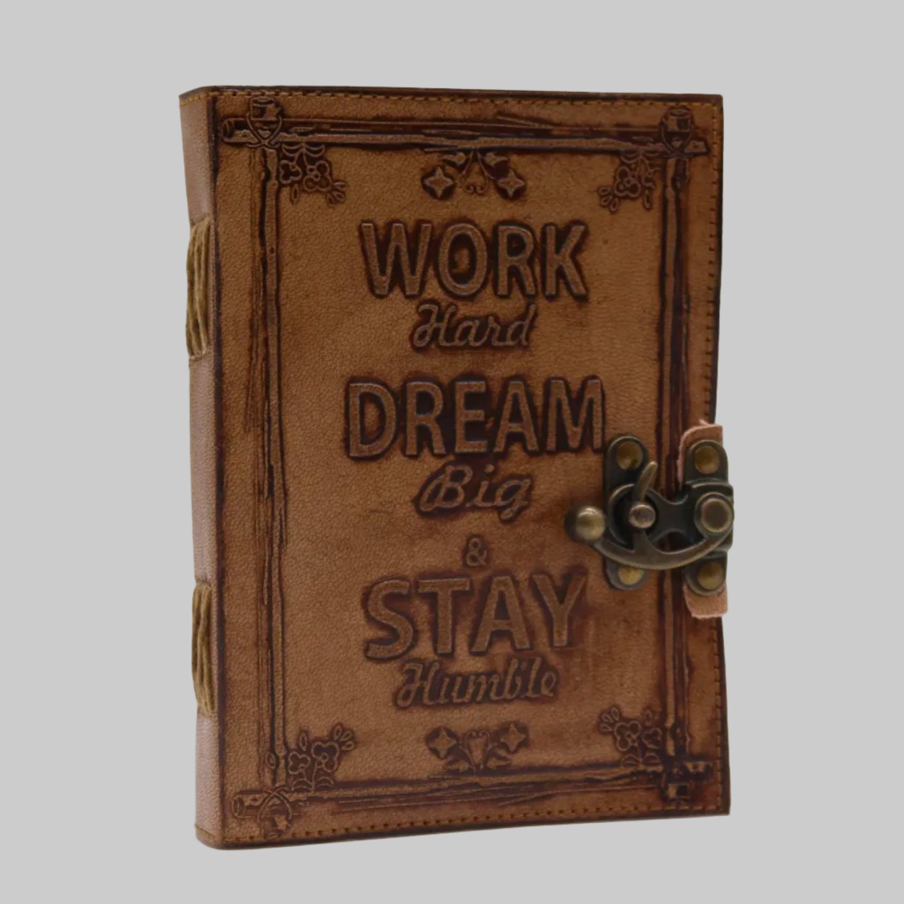 Brown leather notebook with motivational quote on a white background