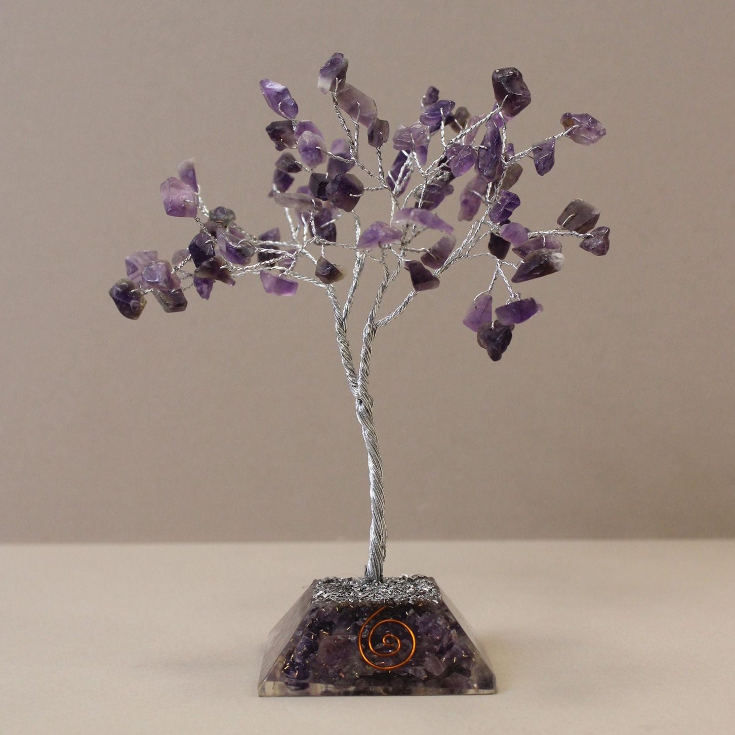 Amethyst crystal tree on a beige background