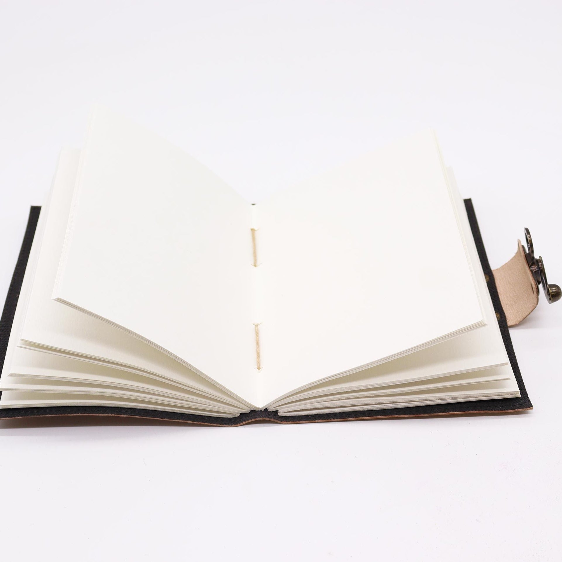 Open book with black leather binding on a white background