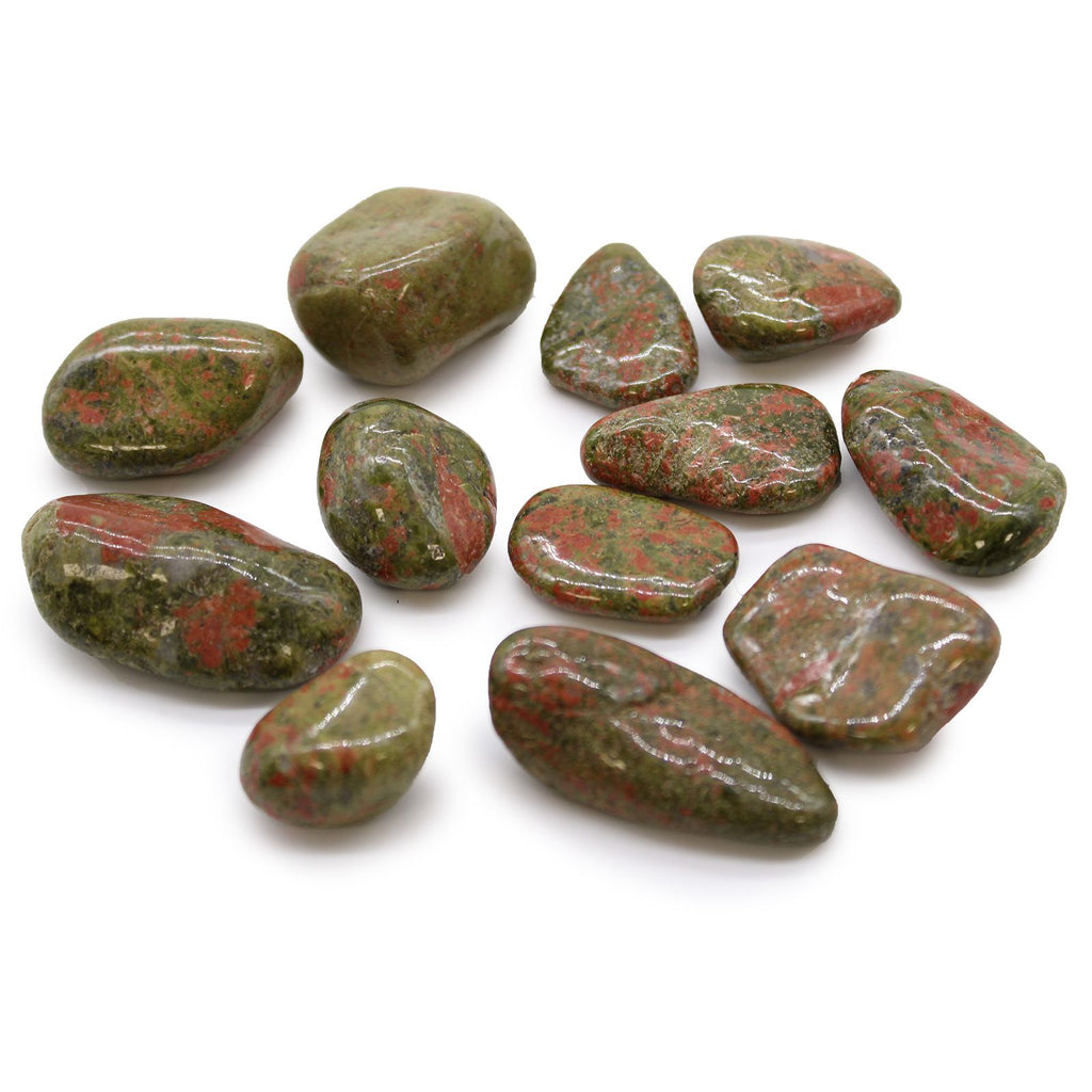 Collection of green and red stones on a white background