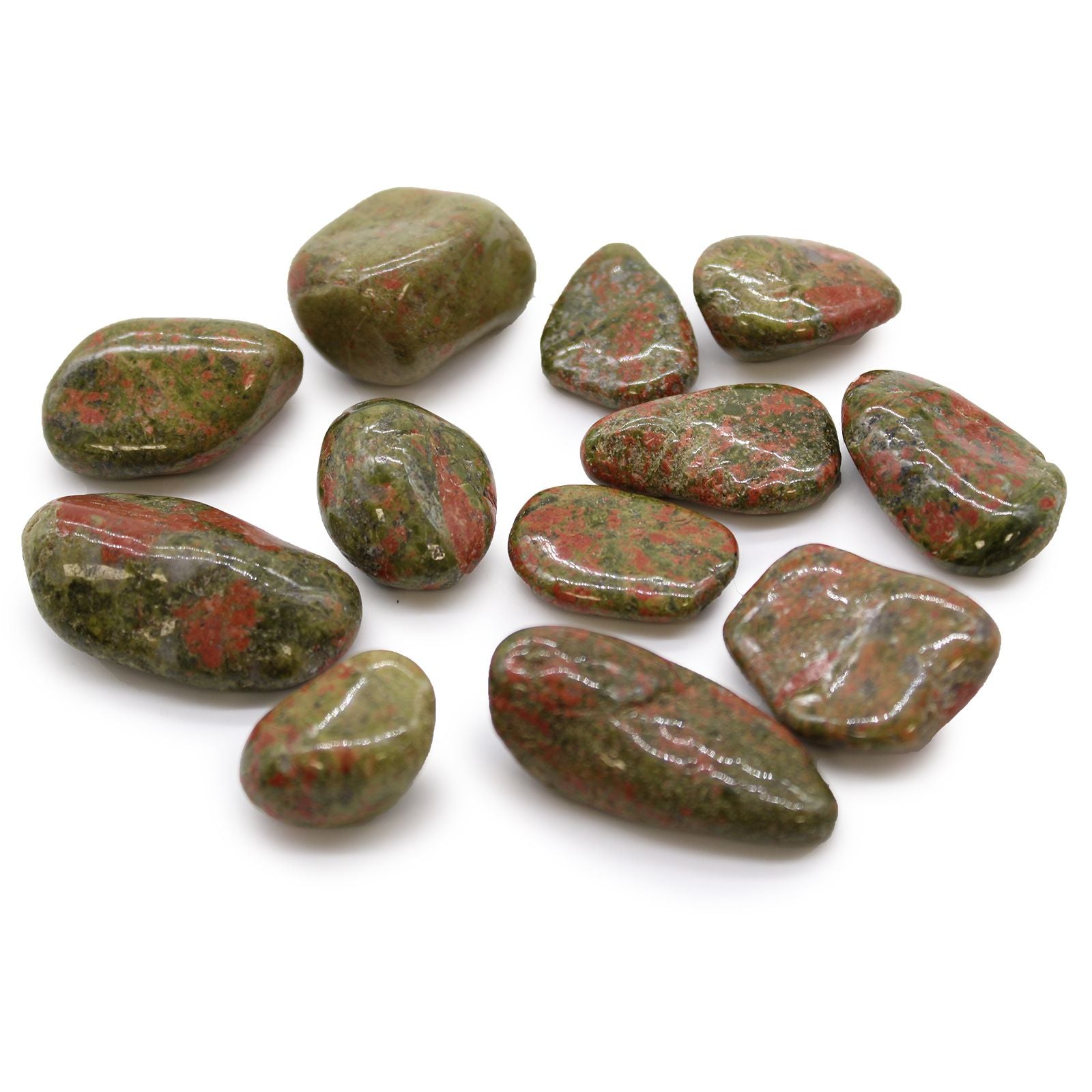 Collection of green and red stones on a white background