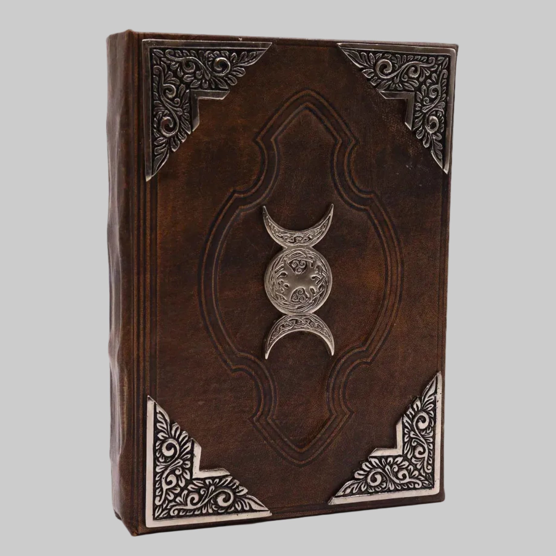 Decorative leather book with embossed design and silver emblem on a white background