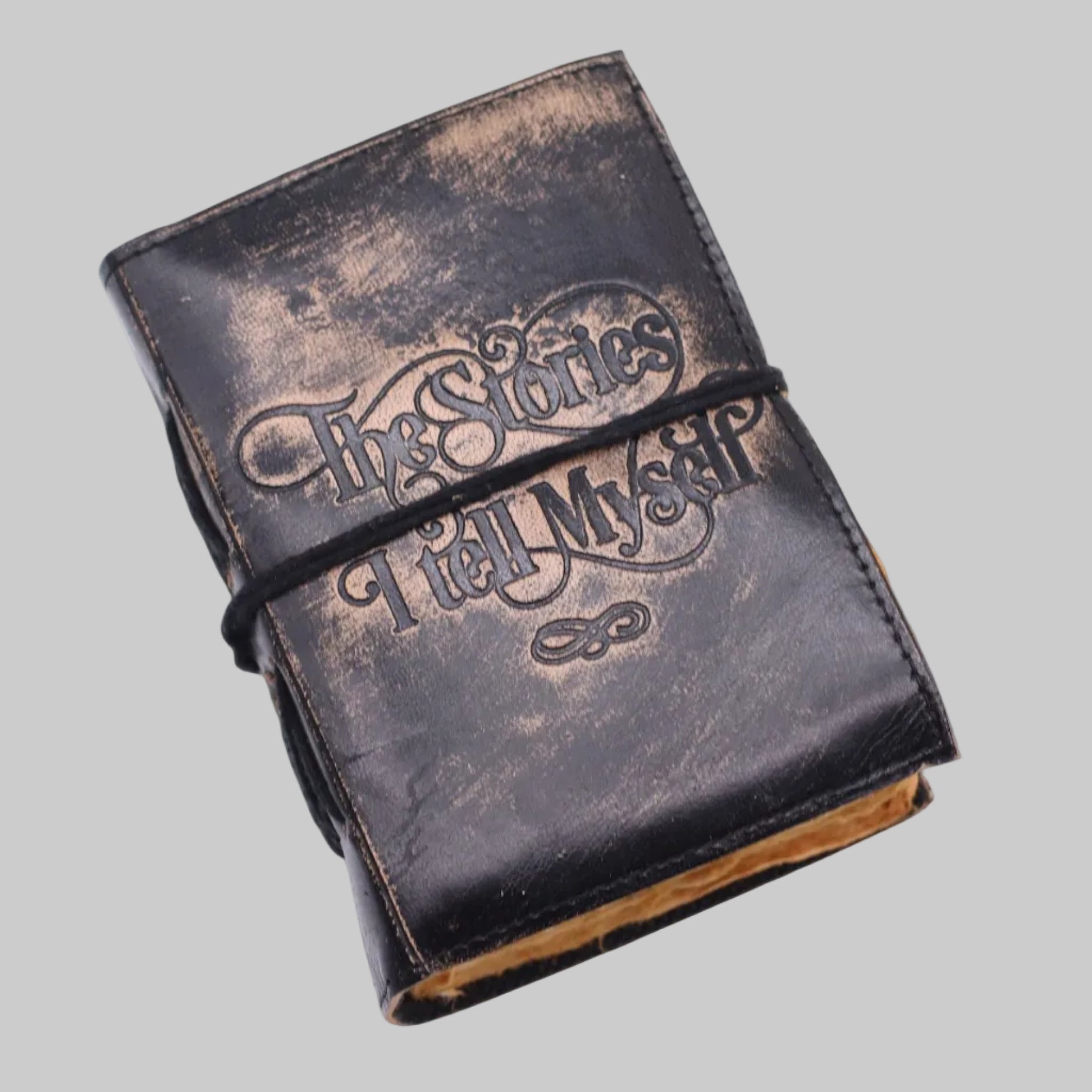 Vintage-style leather-bound book with embossed text on a white background