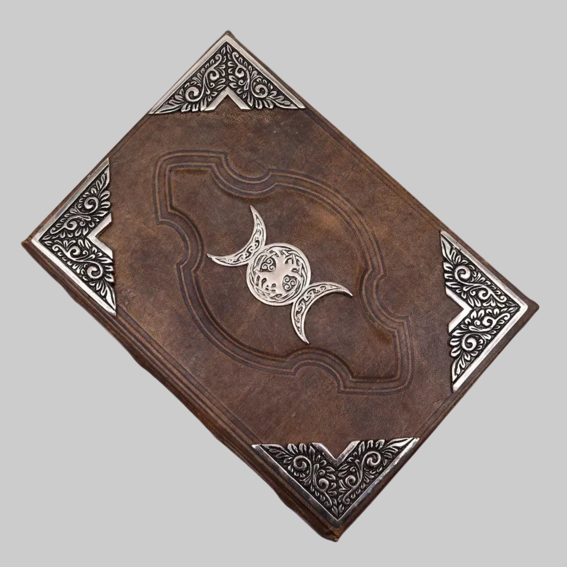 Decorative leather-bound book with embossed design on a white background