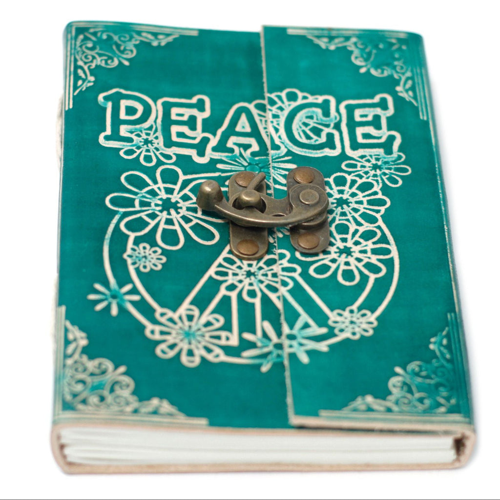 Turquoise notebook with 'PEACE' design and metal clasp on a white background