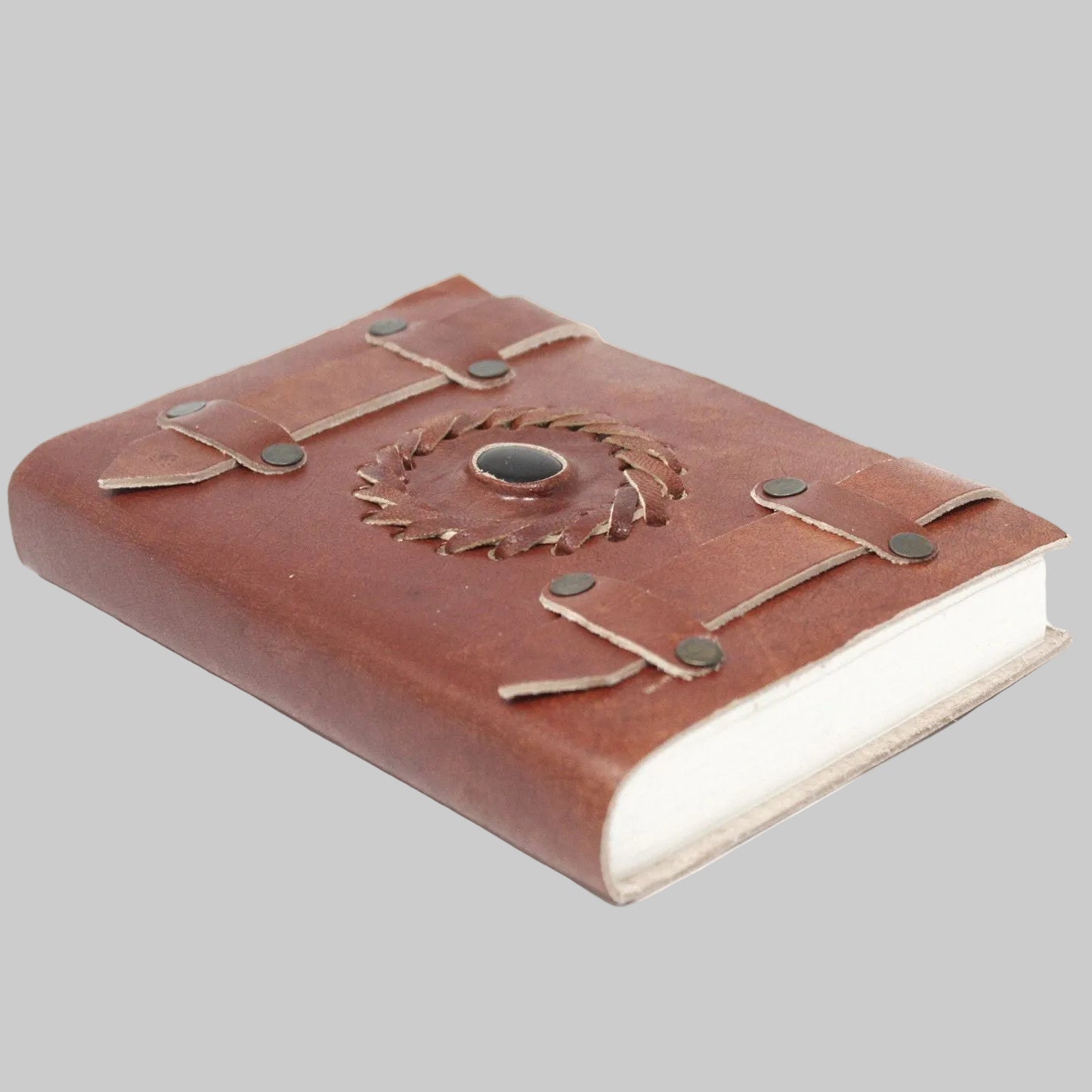 Brown leather notebook with decorative stitching on a white background