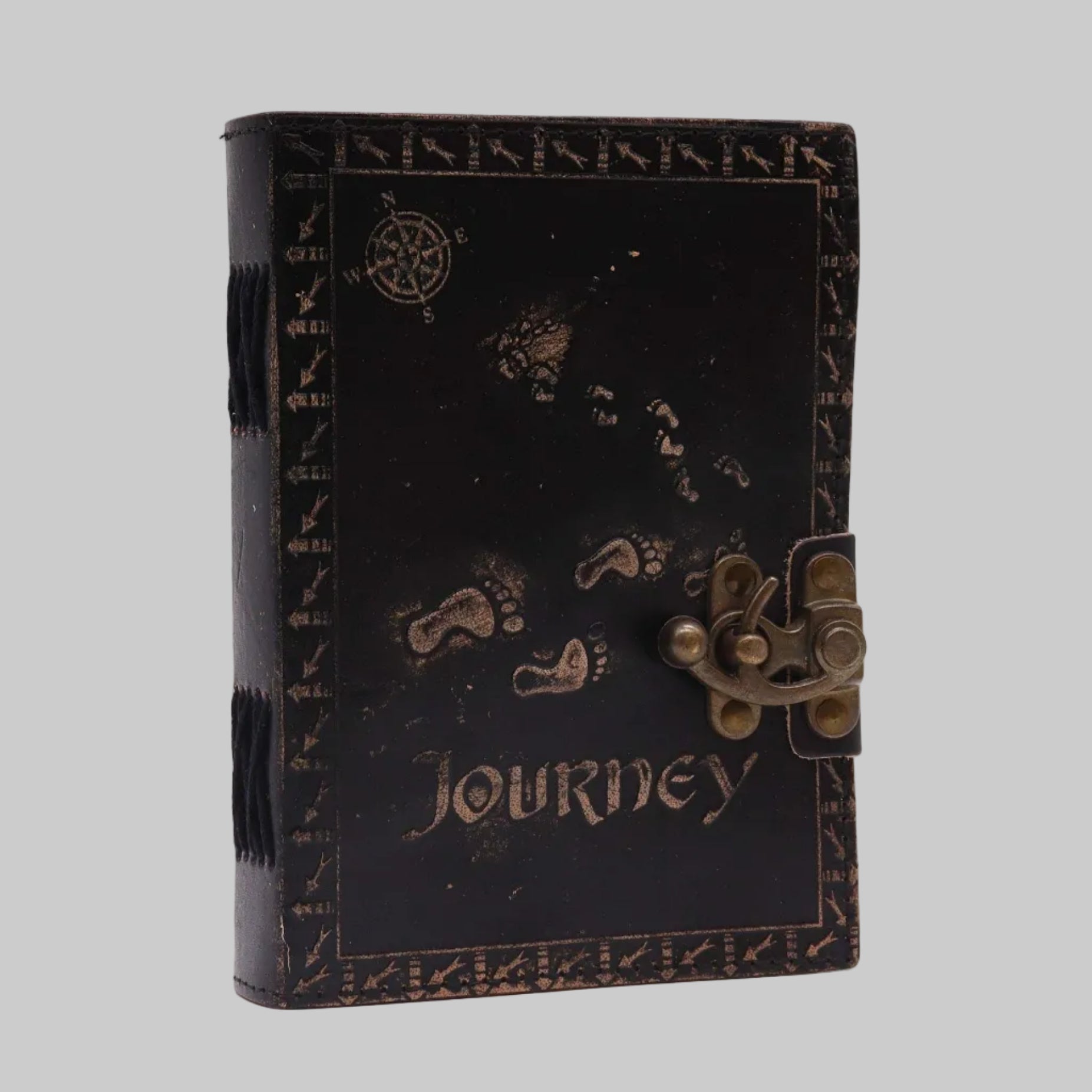 Black leather journal with 'Journey' text and decorative elements on a white background