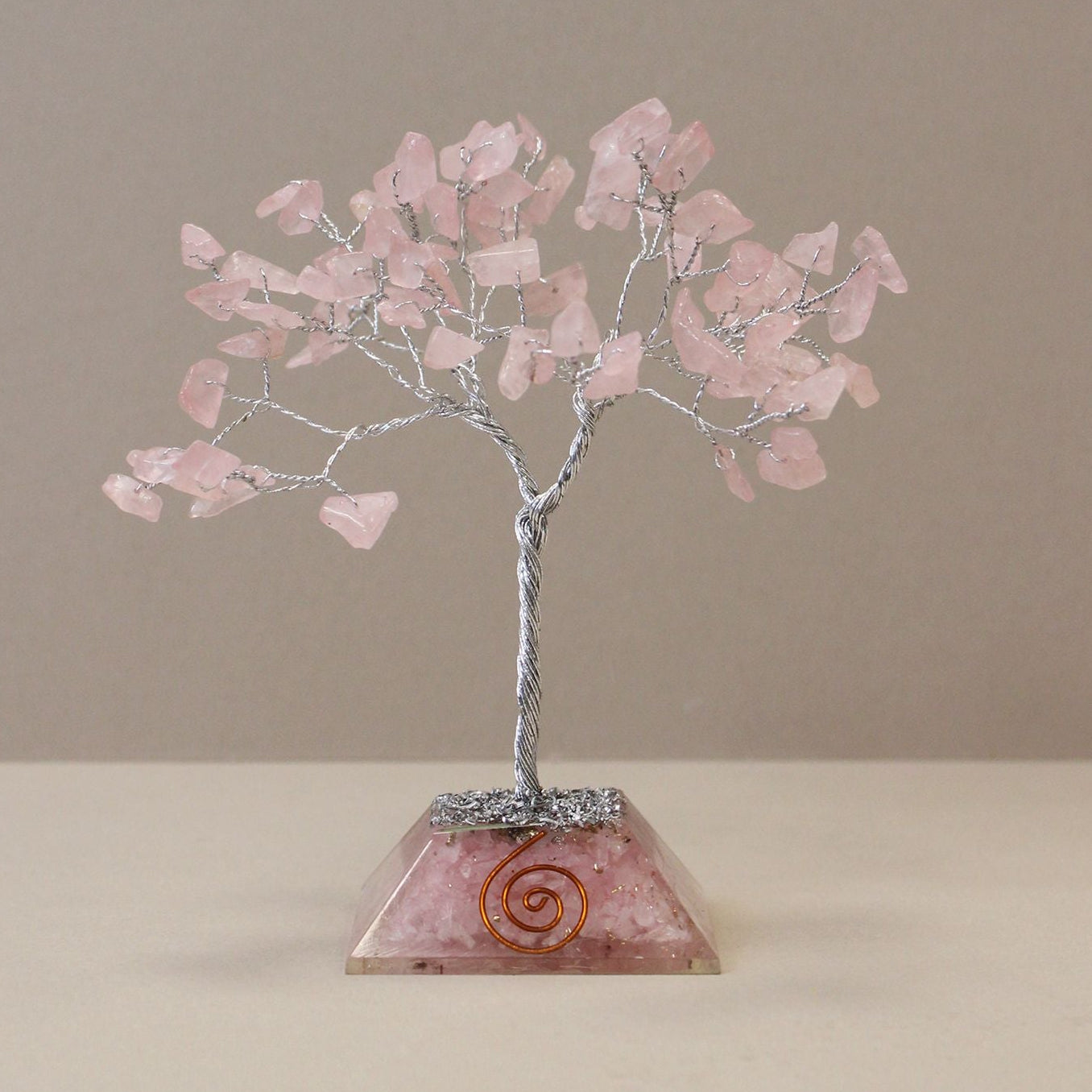 Decorative tree with pink leaves on a brown background