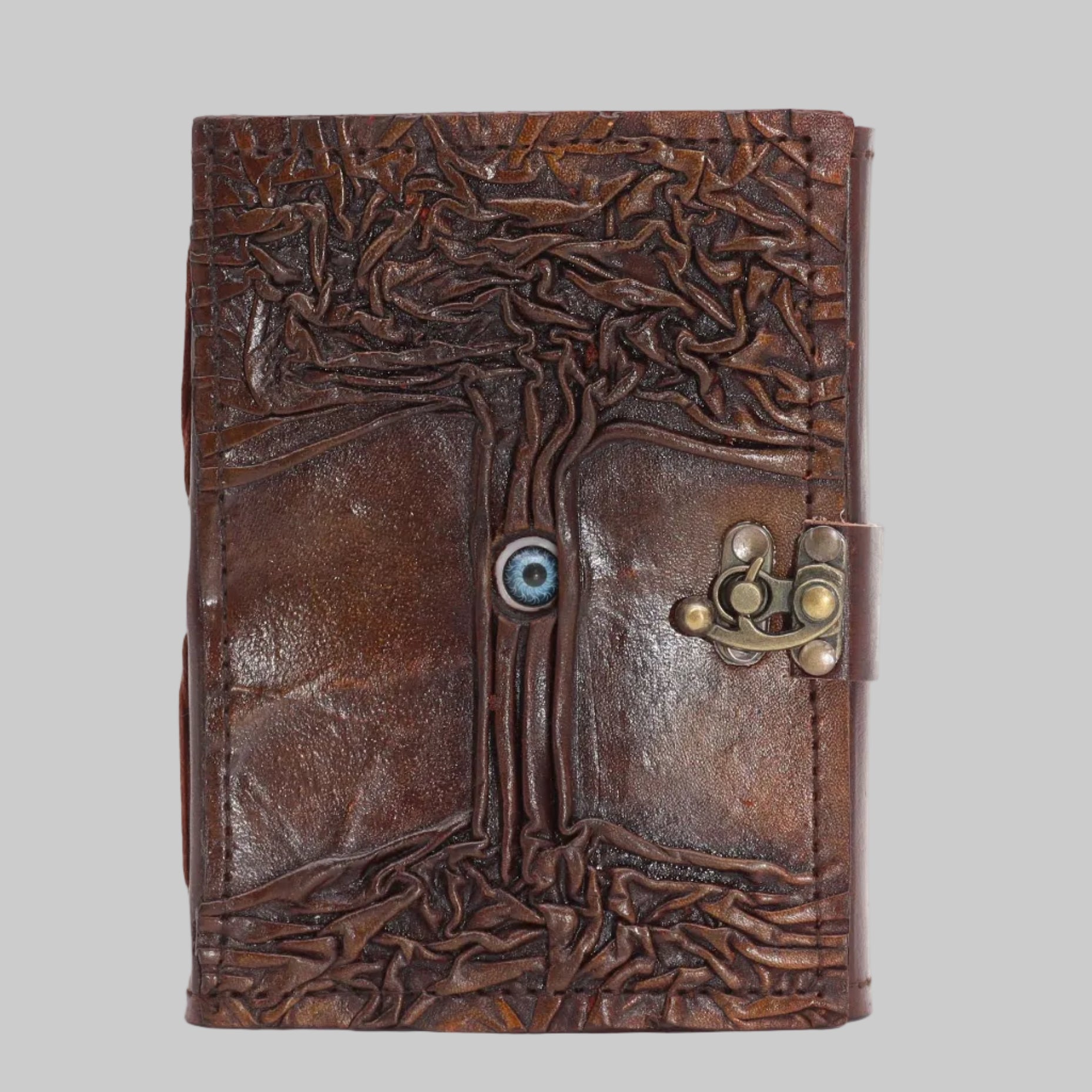 Brown leather journal with tree design and metal clasp on a white background