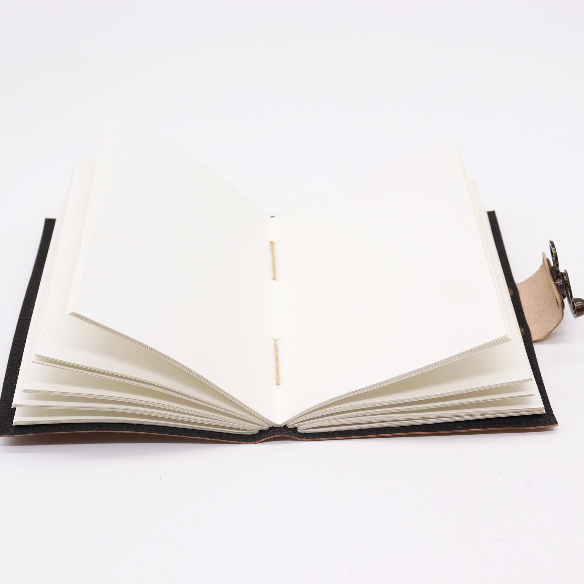 Open book with black leather binding on a white background