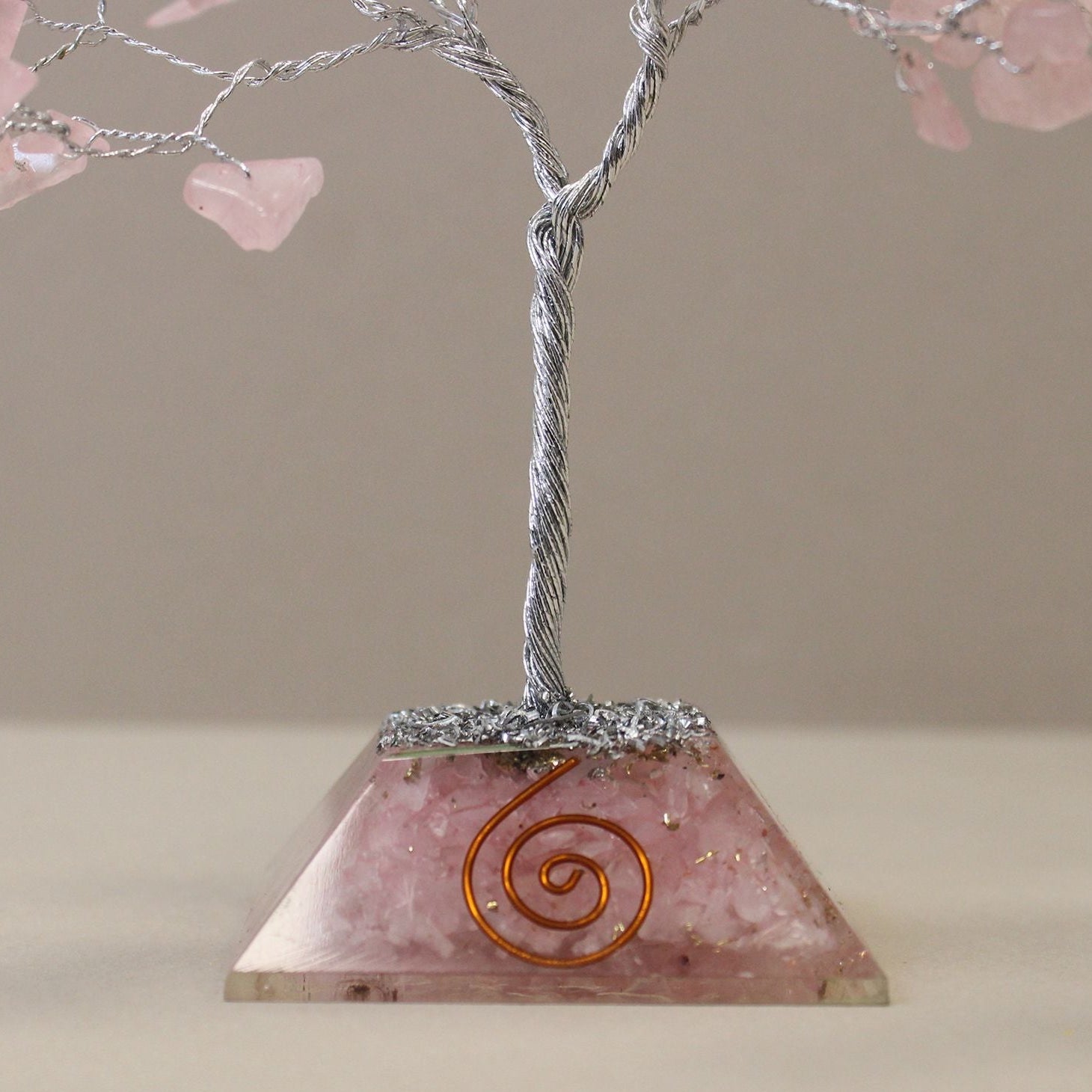Decorative pyramid with a spiral design on a beige background