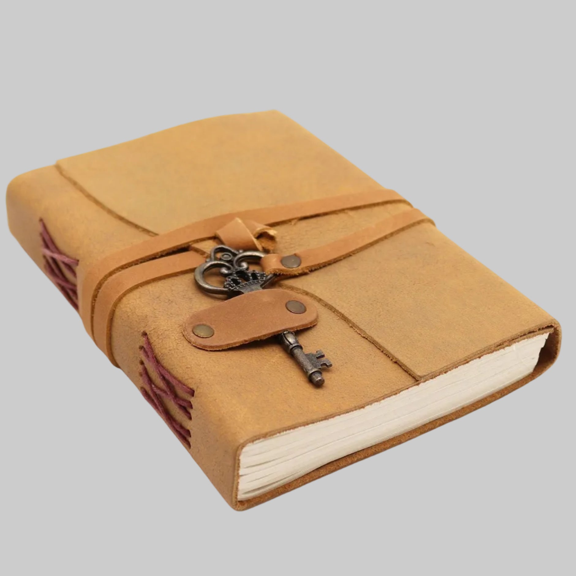Brown leather-bound notebook with a key charm on a white background