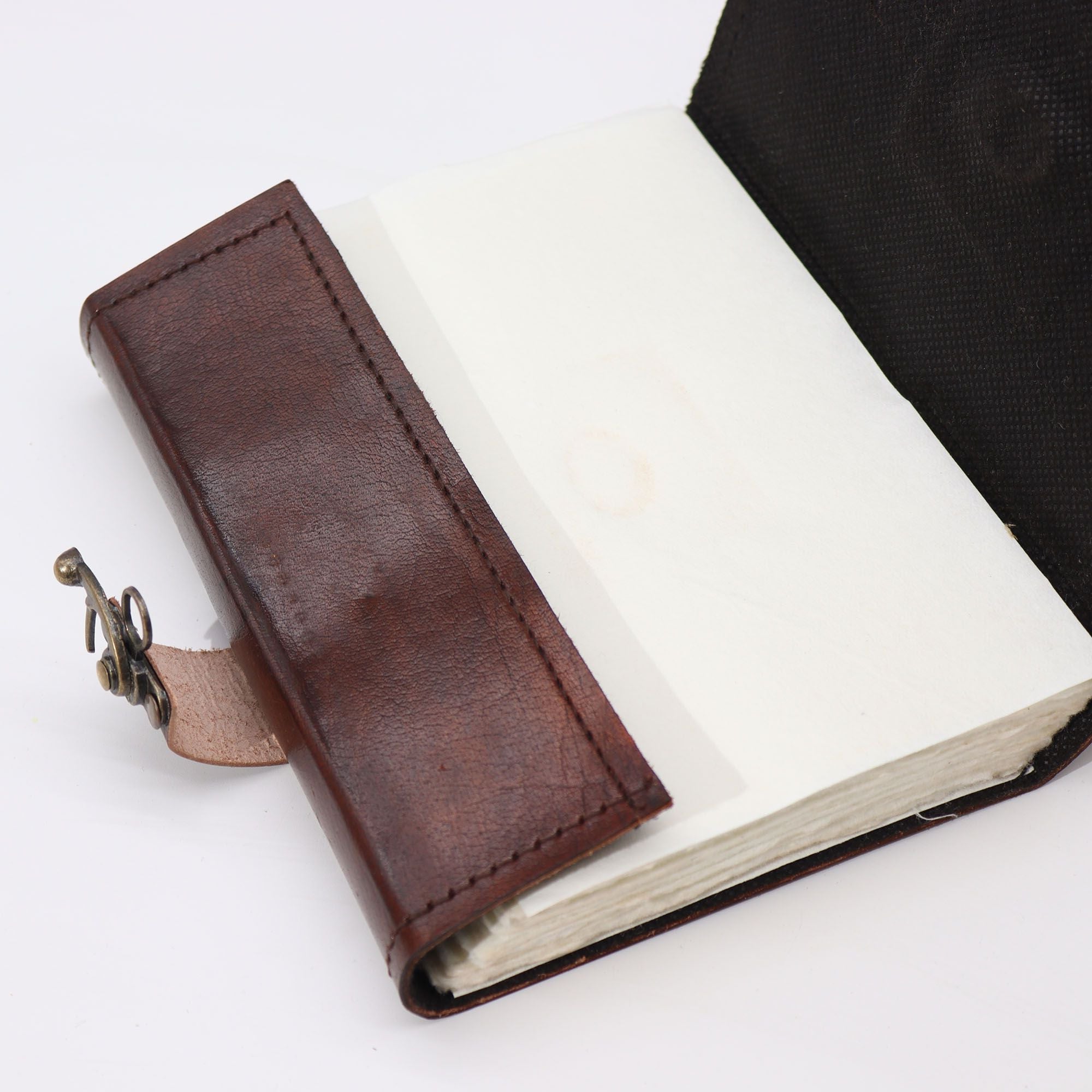 Brown leather-bound book with a strap on a white background
