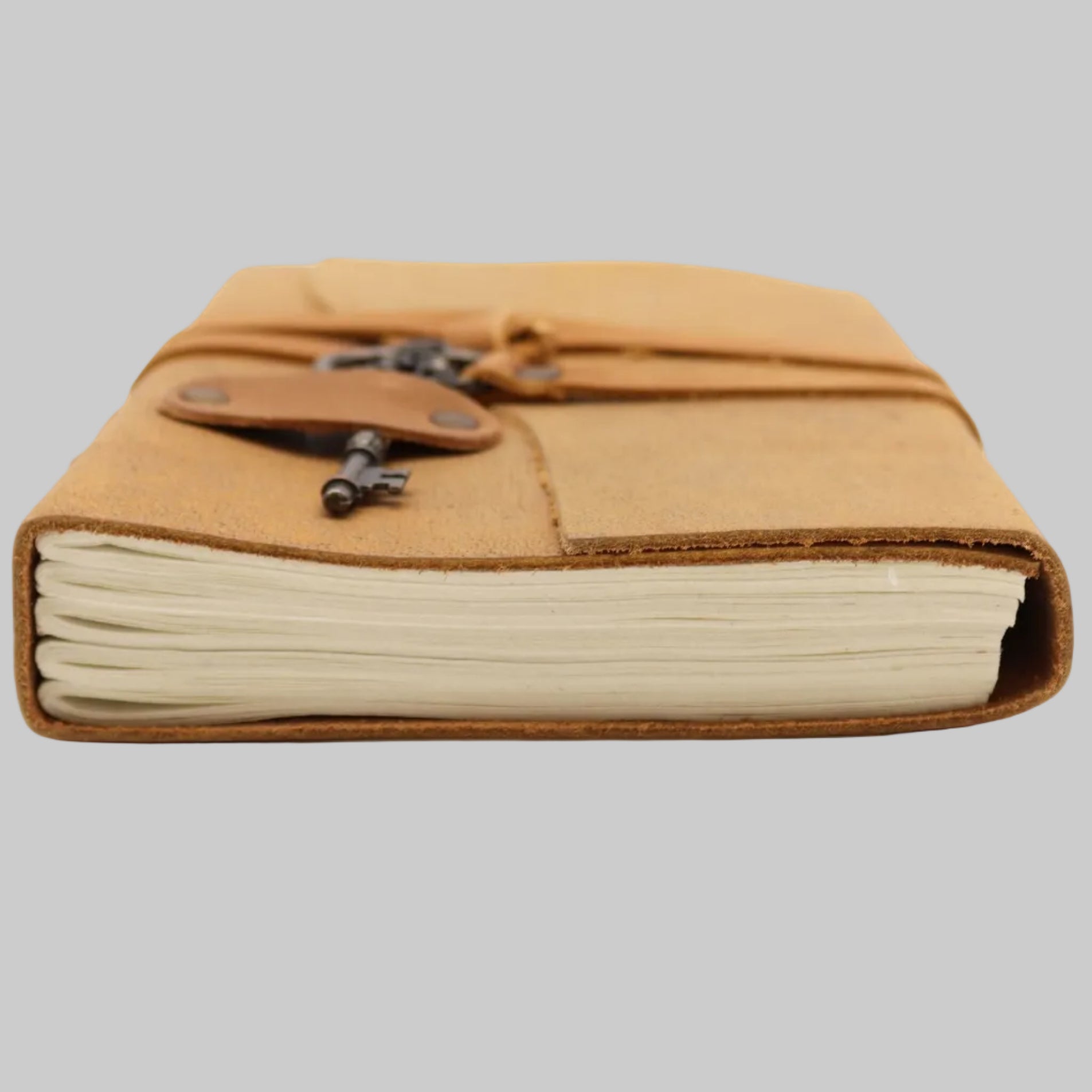 Brown leather-bound notebook with a key on a white background