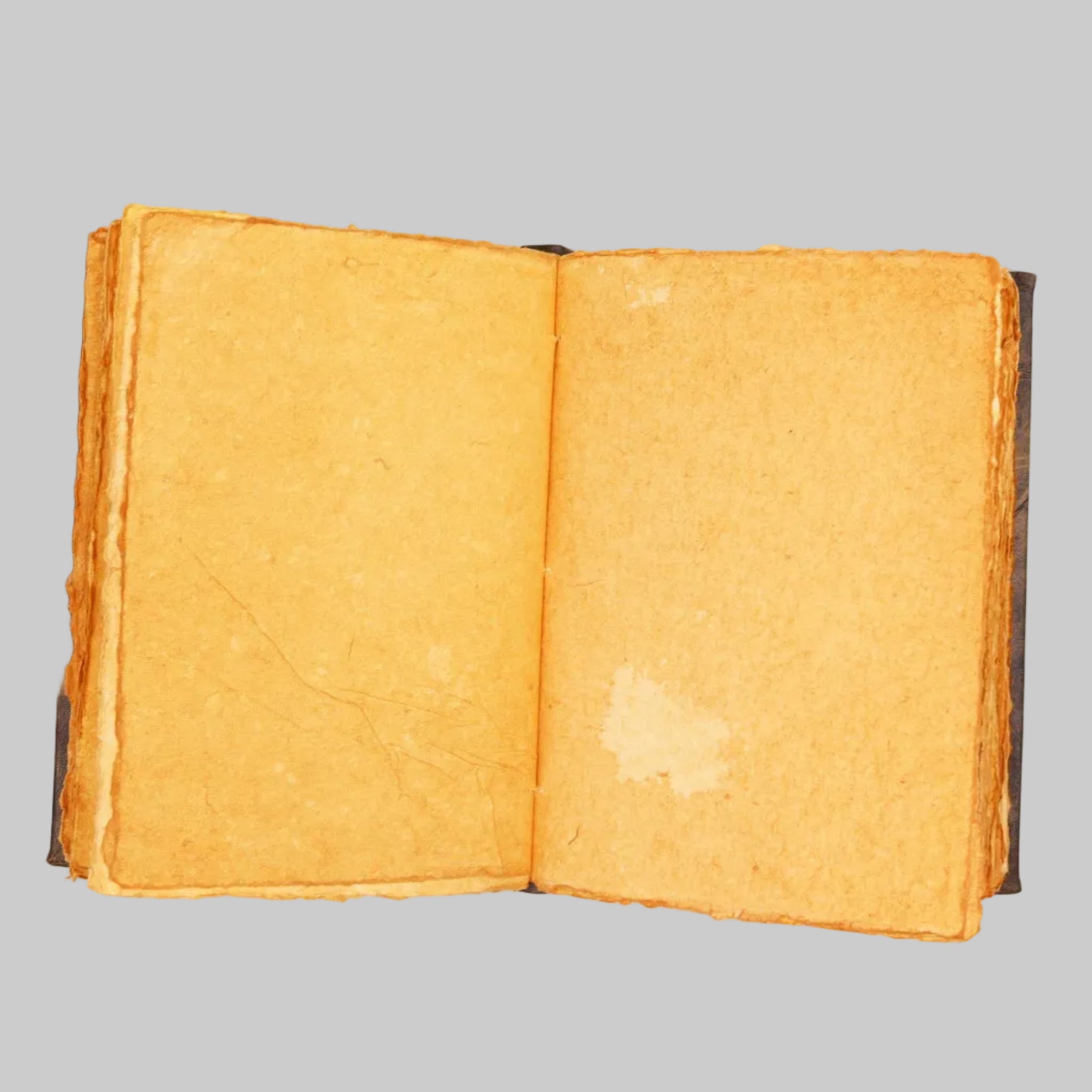 Open book with yellowed pages on a white background