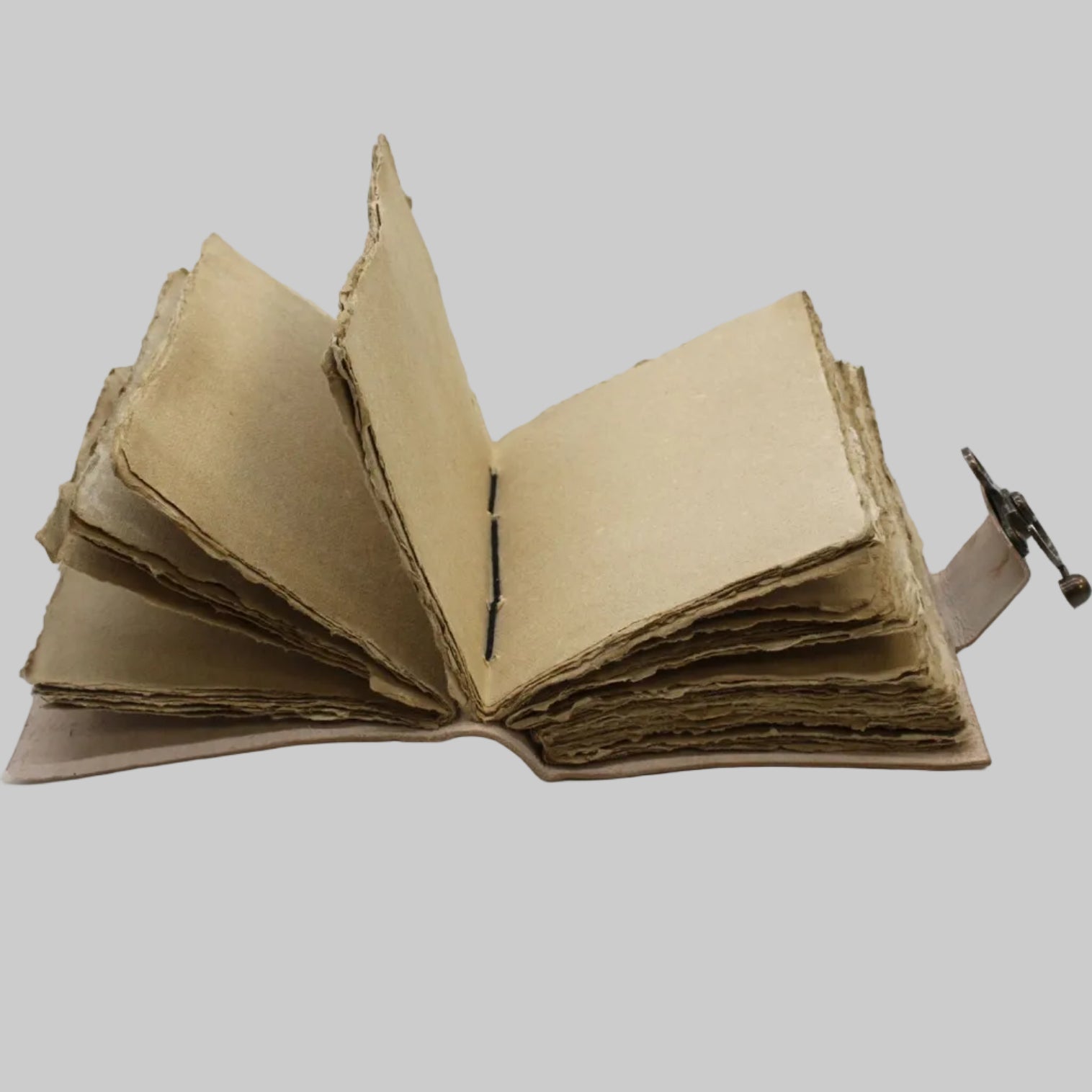 Open cardboard book with a strap on a white background