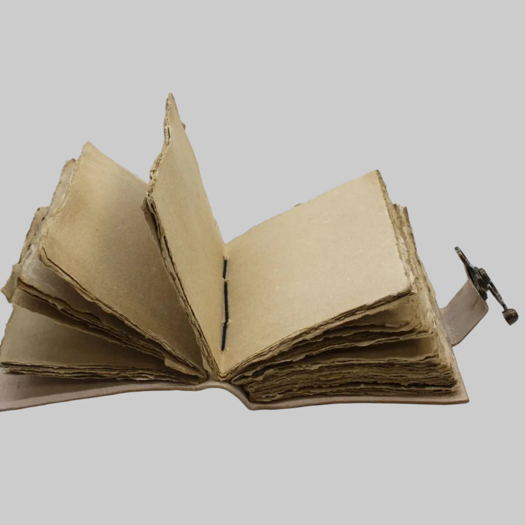Open cardboard book with a strap on a white background