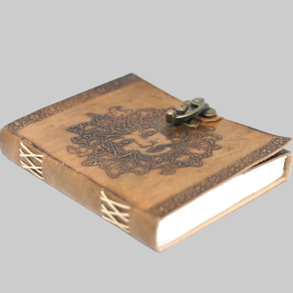 Wooden notebook with decorative embossing and a metal clasp on a white background