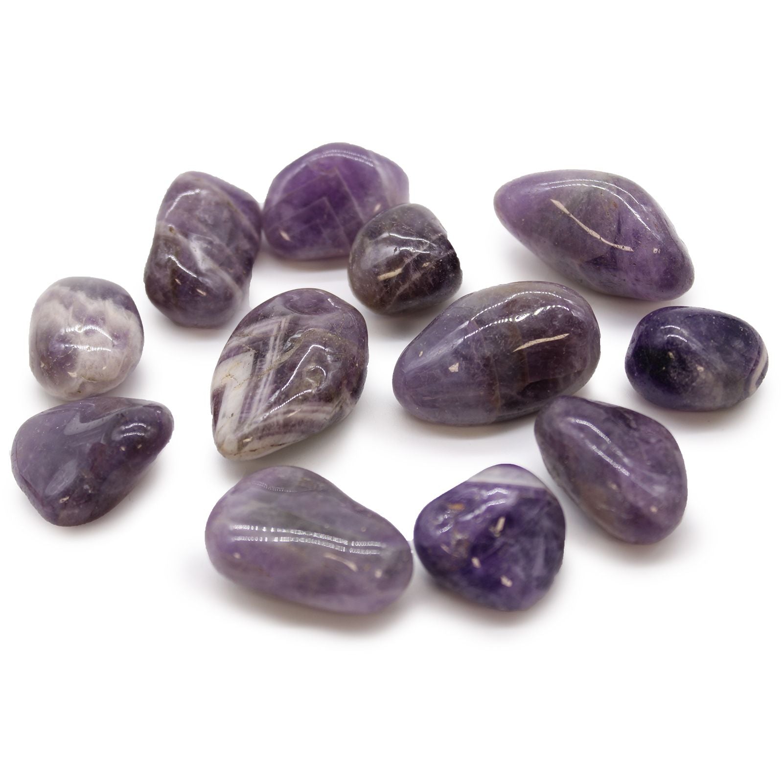 Purple stones with visible carvings on a white background