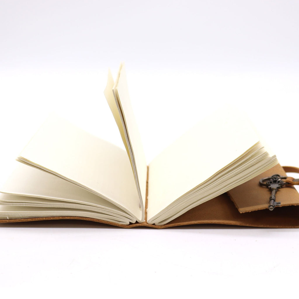 Open book with a leather cover and cross bookmark on a white background