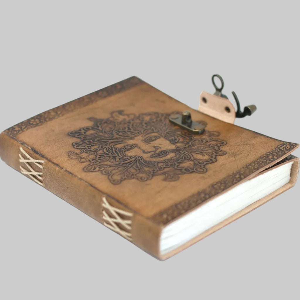 Wooden notebook with decorative cover and clip on a white background
