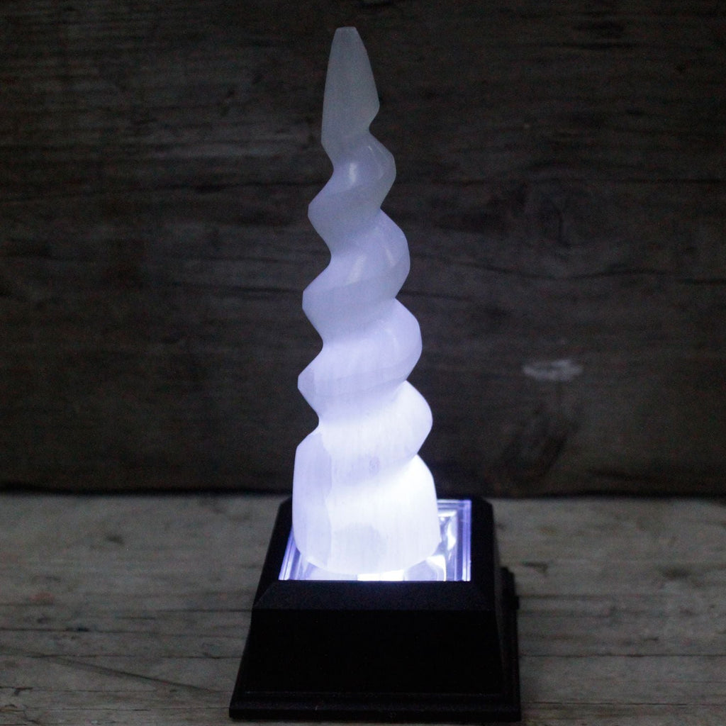 Decorative spiral light on a wooden surface with a dark background