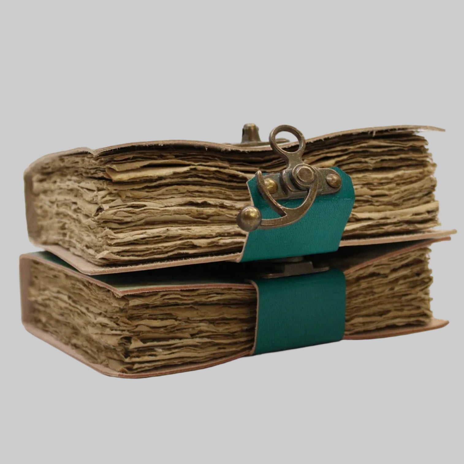 Vintage-style book with leather binding and decorative clasp on a white background