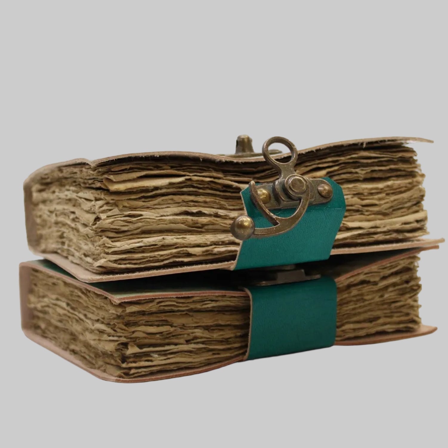 Vintage-style book with leather binding and decorative clasp on a white background