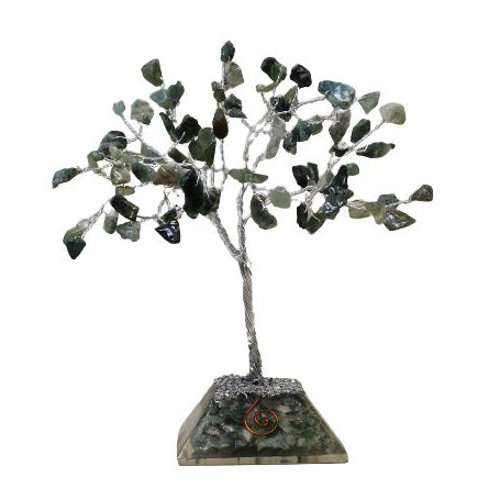 Decorative tree sculpture with green leaves on a white background